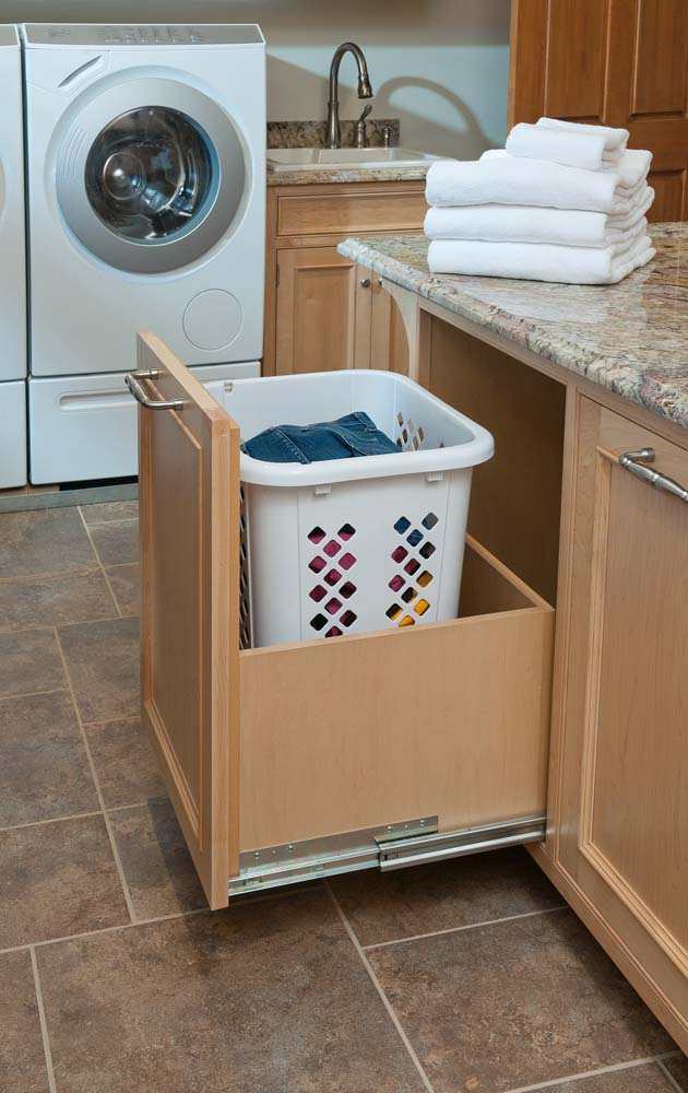 Slide out laundry hamper custom built by Crown Point Cabinetry